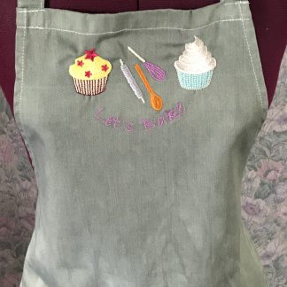 Green embroidered child's apron