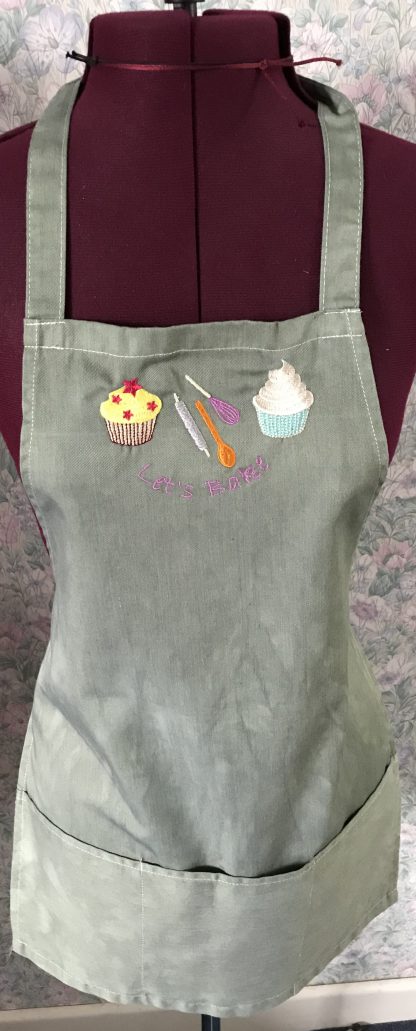 Green embroidered child's apron